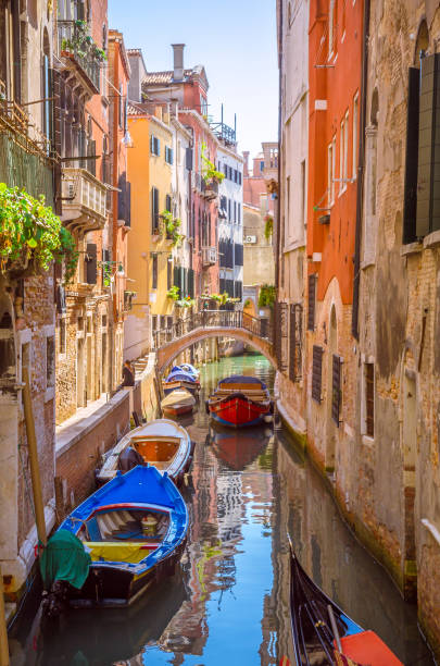 traditional narrow canal with gondolas in venice, italy - venice italy rialto bridge italy gondola imagens e fotografias de stock