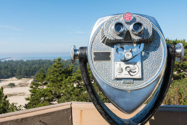 istock Dollar quarter binoculars at a high point of view over the Oregon dunes. 1086097232