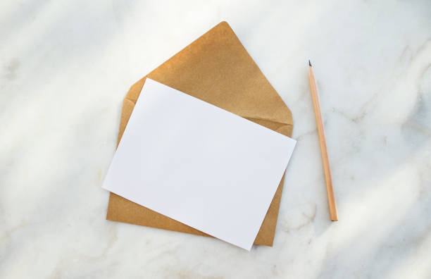 istock Envelope, white blank paper and pencil on a white background. 1086102342