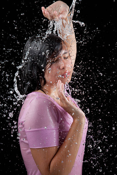 Water splash on woman face. stock photo