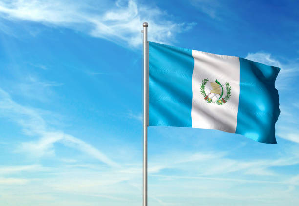 istock Guatemala flag waving cloudy sky background 1086106376