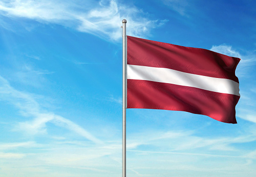 Latvia flag on flagpole waving cloudy sky background realistic 3d illustration with copy space