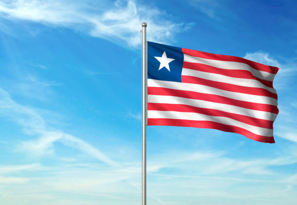 istock Liberia flag waving cloudy sky background 1086106438