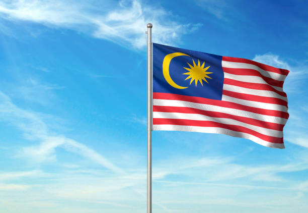 istock Malaysia flag waving cloudy sky background 1086106468