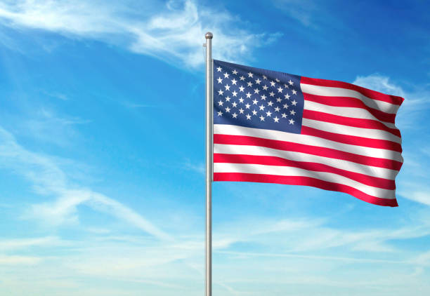istock United States flag waving cloudy sky background 1086109920