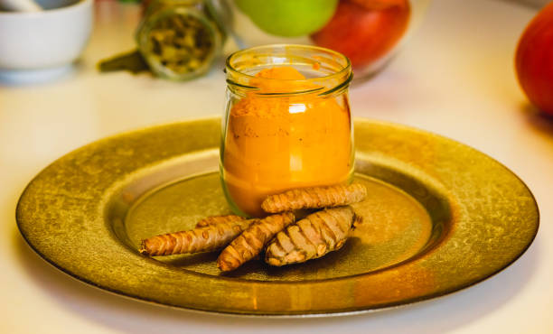 colorful indian spices turmeric and cardamom in a glass jar and mortar for spices close up. - cardamom cinnamon mortar and pestle herb imagens e fotografias de stock