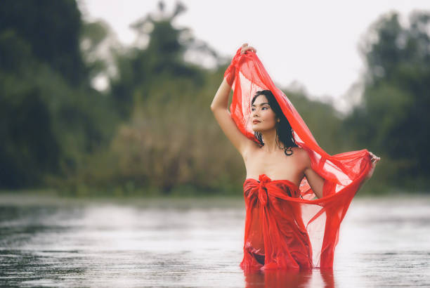 istock Young Woman Standing In Lake 1086119292