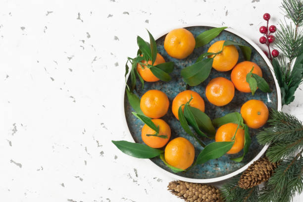 istock Christmas composition with tangerine, fir branches and pine cones 1086126136