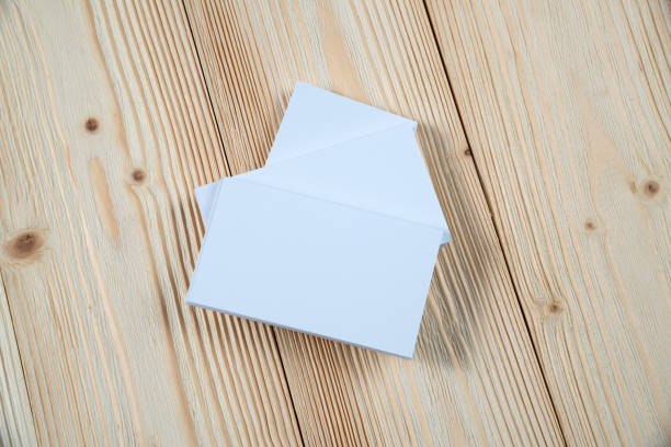 istock Blank business cards on wooden working table with copy space for add text ID. and logo, business company concept. 1086131108