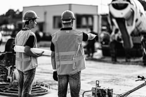 istock Rear View Of Engineers Standing At Construction Site 1086132182