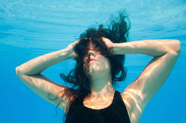 istock Female Model Swimming In Pool 1086136544
