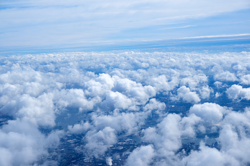 Fluffy cloudy cloudscape view from airplane window