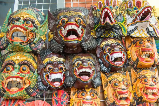 Photo of Traditional Barong mask hanging for souvenir sell in Ubud market, Bali island of Indonesia.
