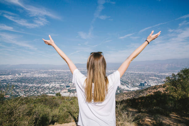 istock Woman's Arms Outstretched overlooking City 1086151632