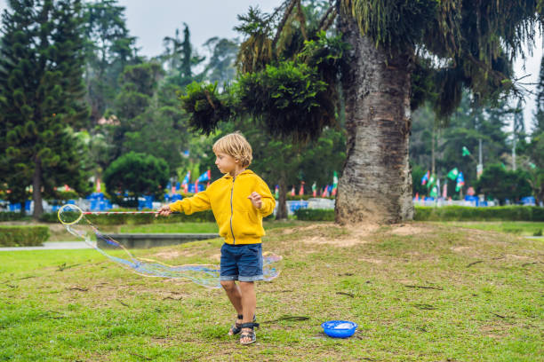 istock Cute little boy is playing with big bubbles outdoor 1086159180