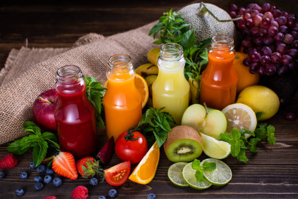 a set of  colorfull fresh vegetables and fruits juice in glasses bottles on wooden background, concept for heathy food and drink in daily life. - heathy food imagens e fotografias de stock