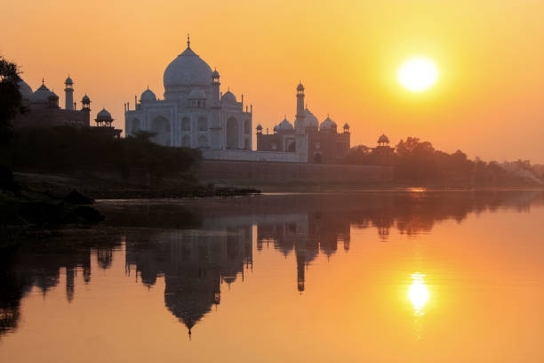Taj Mahal reflected in Yamuna river at sunset in Agra, India stock photo