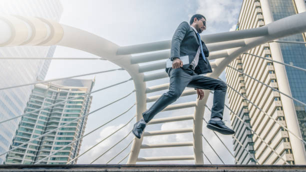 istock Asian businessman jumping with tablet on hand 1086178870
