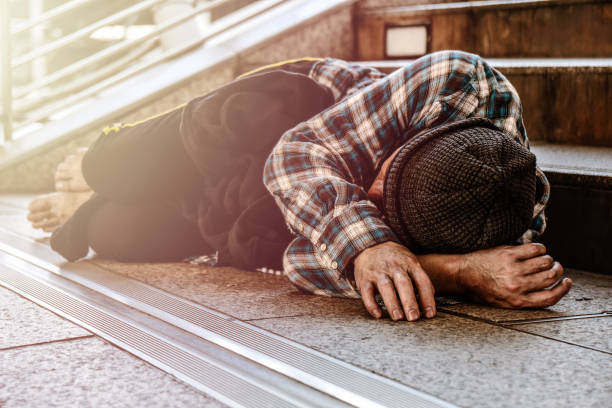 istock Asian male poor homeless man sleeping on pathway with suffering and sad 1086178884