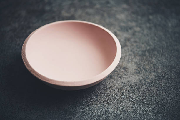 Pink wooden bowl on gray table top