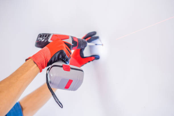 istock Man twists a screw into the wall 1086184606