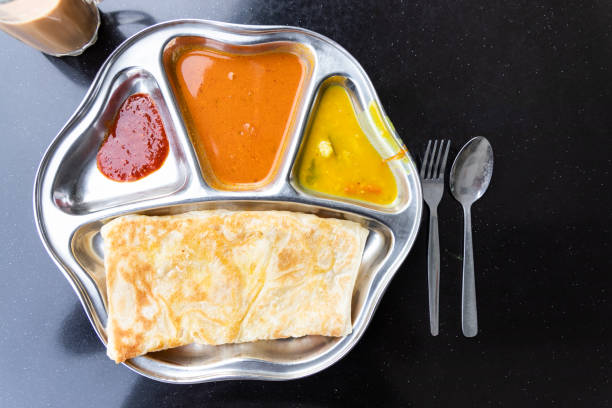 Roti prata or canai set with curry, dhal and sambal Roti prata or canai set with curry, dhal and sambal. Favorite breakfast in Malaysia roti canai stock pictures, royalty-free photos & images