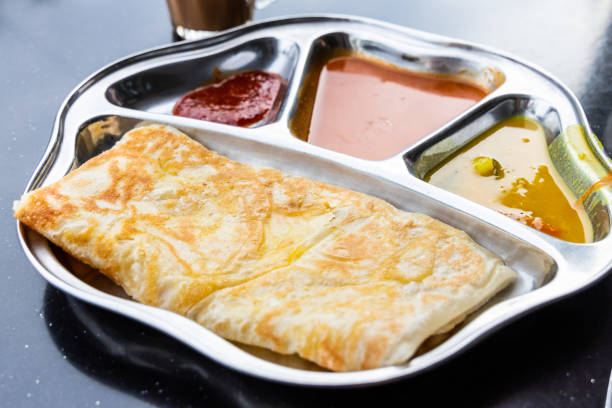 Roti prata or canai set with curry, dhal and sambal Roti prata or canai set with curry, dhal and sambal. Favorite breakfast in Malaysia roti canai stock pictures, royalty-free photos & images