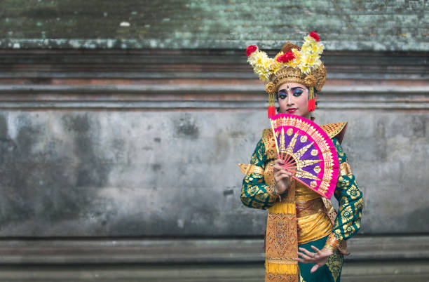 close up of balinese legong dancer in traditional makeup and outfit