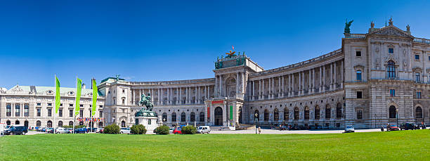 Sunny day at the Hofburg Palace in Vienna, Austria The majestic Hofburg Place (13th Century) on a clear summers day in the beautiful city of Vienna. Stitched panorama detailed when viewed large. hofburg imperial palace stock pictures, royalty-free photos & images