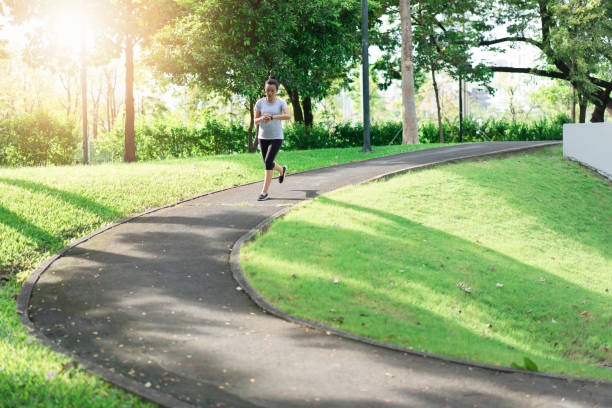 istock Woman running at public park.  Workout concept 1086203238