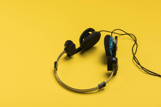 istock headphones on a yellow background 1086203404