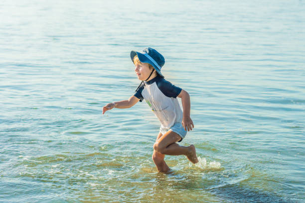 istock happy little boy running on sand tropical beach 1086205204