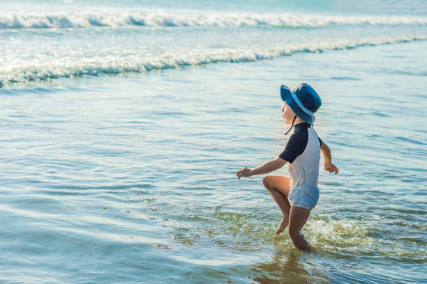 istock happy little boy running on sand tropical beach 1086205218