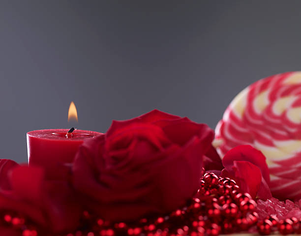 Candle, lollipop, roses and pearls stock photo