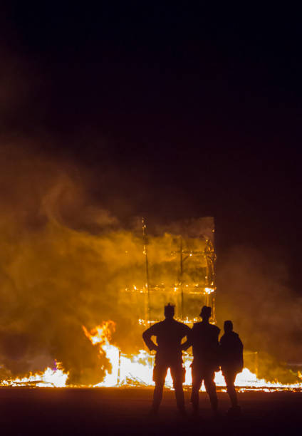 istock Three People Watch as a Building Burns to the Ground 1086217764