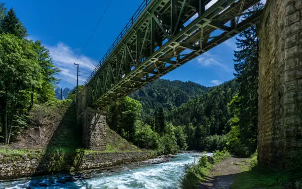 A Steel railroad bridge leading over a river