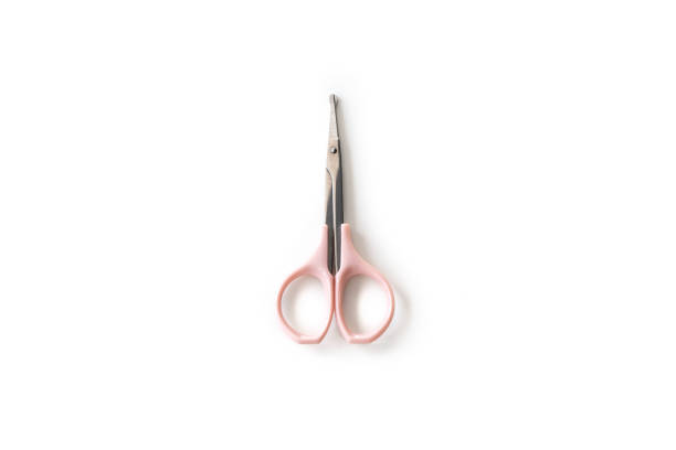 scissors trimming nose hair on isolated white background