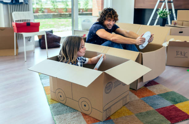 istock Father and son playing car racing with cardboard boxes 1086231958
