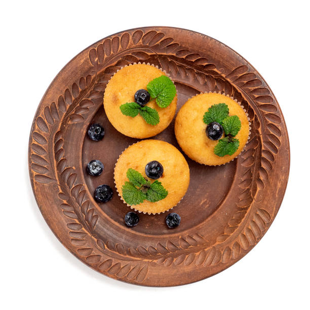 istock Blueberry muffins on brown plate. Isolated on white background. Top view 1086236754