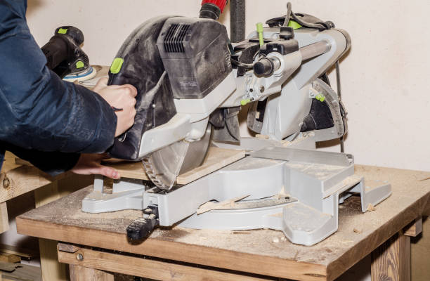 istock Joiner's machine with a circular saw, a man cuts the board. Work process, employment, job search, in the enterprise, the manufacture of wooden products 1086239428