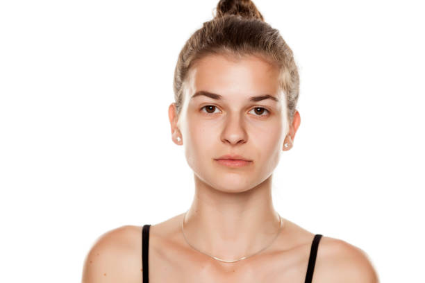 istock Young serious woman without makeup on white background 1086242818