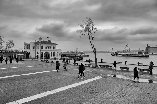 stanbul, Turkey - Dec 20, 2018 : Rainy day at The Istanbul, Kadikoy seaside. Some people are walking Kadikoy pier.