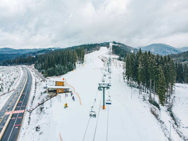 istock BUKOVEL, UKRAINE - December 9, 2018 - people skiing and snowboarding down by hill. winter activity 1086261542