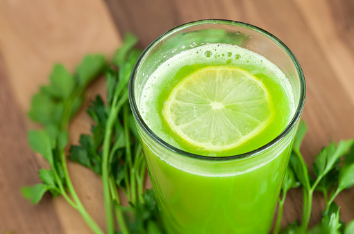 Fresh homemade celery apple juice with lemon slice