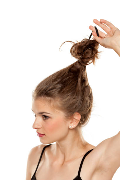 istock Young woman untie her heir on white background 1086265730