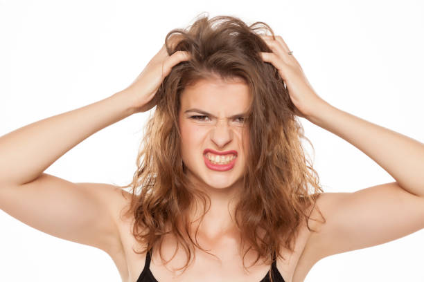 istock Young woman scratching her head on white background 1086265806