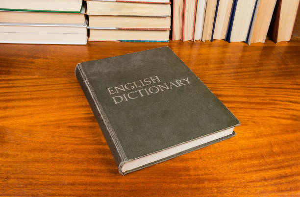 istock Old hardback English dictionary on a wooden table 1086266088