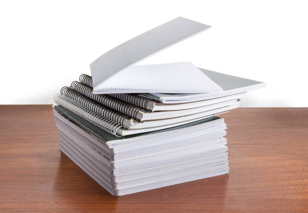 istock Stack of the different exercise books on wooden table 1086267252