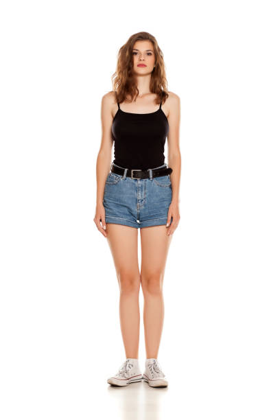 istock Young pretty woman in short jeans standing on white background 1086268152
