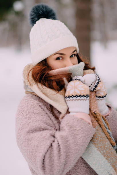 istock female covers her face from cold in snowy woods 1086270360